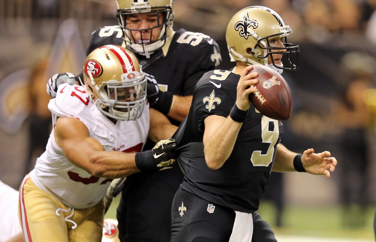 Nov 9, 2014; New Orleans Saints quarterback Drew Brees (9) prepares to throw the ball as San Francisco 49ers linebacker Michael Wilhoite (57) pressures. Mandatory Credit: Chuck Cook-USA TODAY Sports