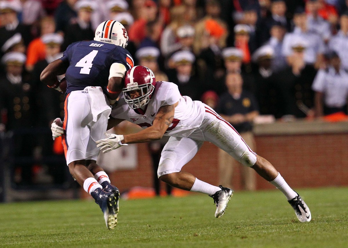 Alabama Crimson Tide defensive back Dee Milliner (28) tackles Auburn Tigers wide receiver Quan Bray (4) at Jordan-Hare Stadium. The Tide defeated the Tigers 42-14.