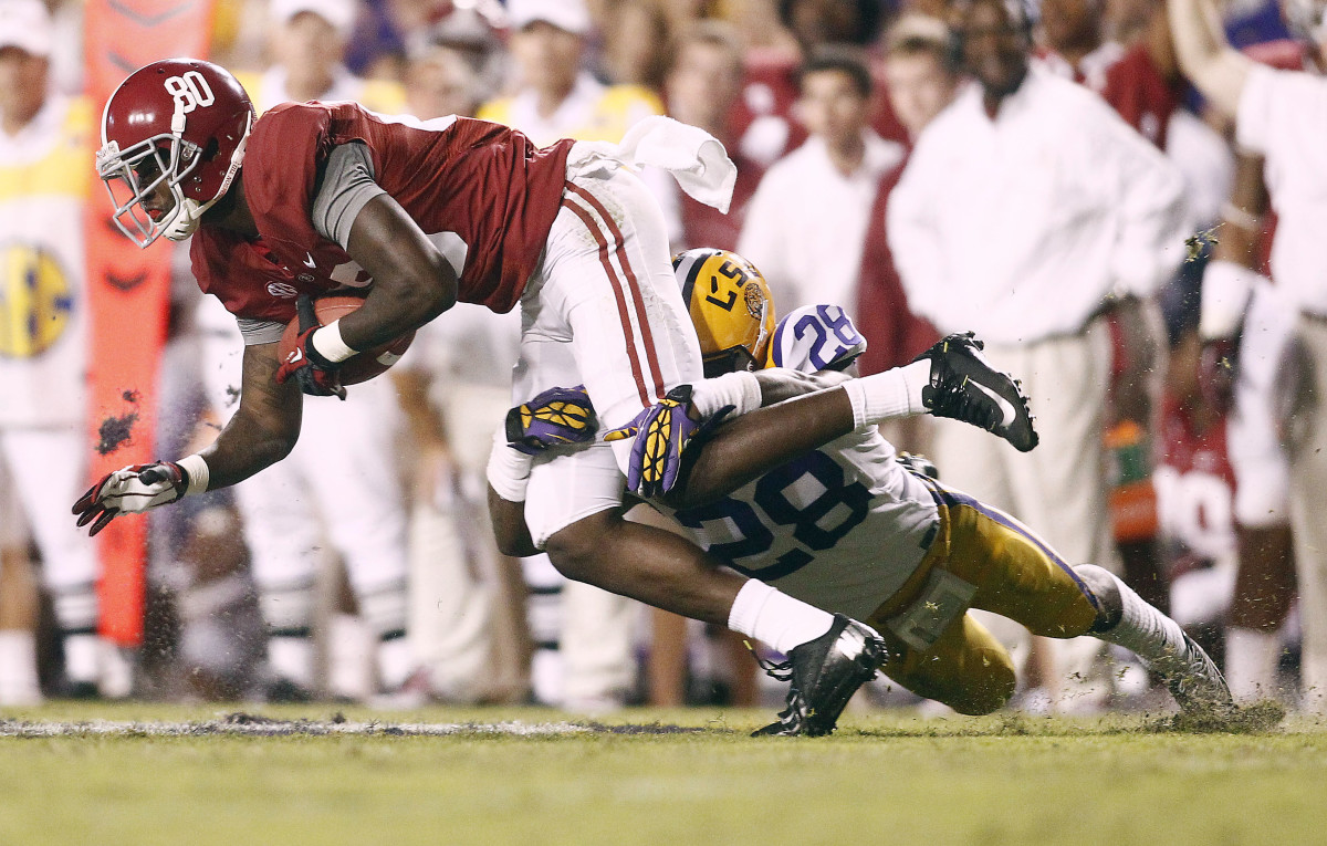 Alabama Crimson Tide wide receiver Marvin Shinn (80) is tackled by LSU Tigers cornerback Jalen Mills (28) during the fourth quarter at Tiger Stadium. Alabama defeated LSU, 21-17.