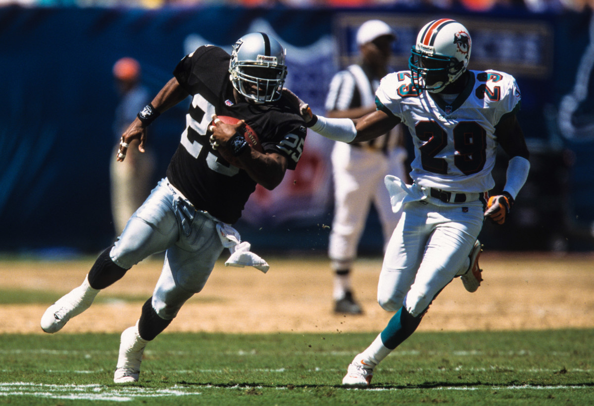 Sep 23, 2001; Miami, FL, USA; FILE PHOTO; Oakland Raiders running back Charlie Garner (25) in action against Miami Dolphins defensive back Sam Madison (29) at Pro Player Stadium. Mandatory Credit: Lou Capozzola-USA TODAY NETWORK