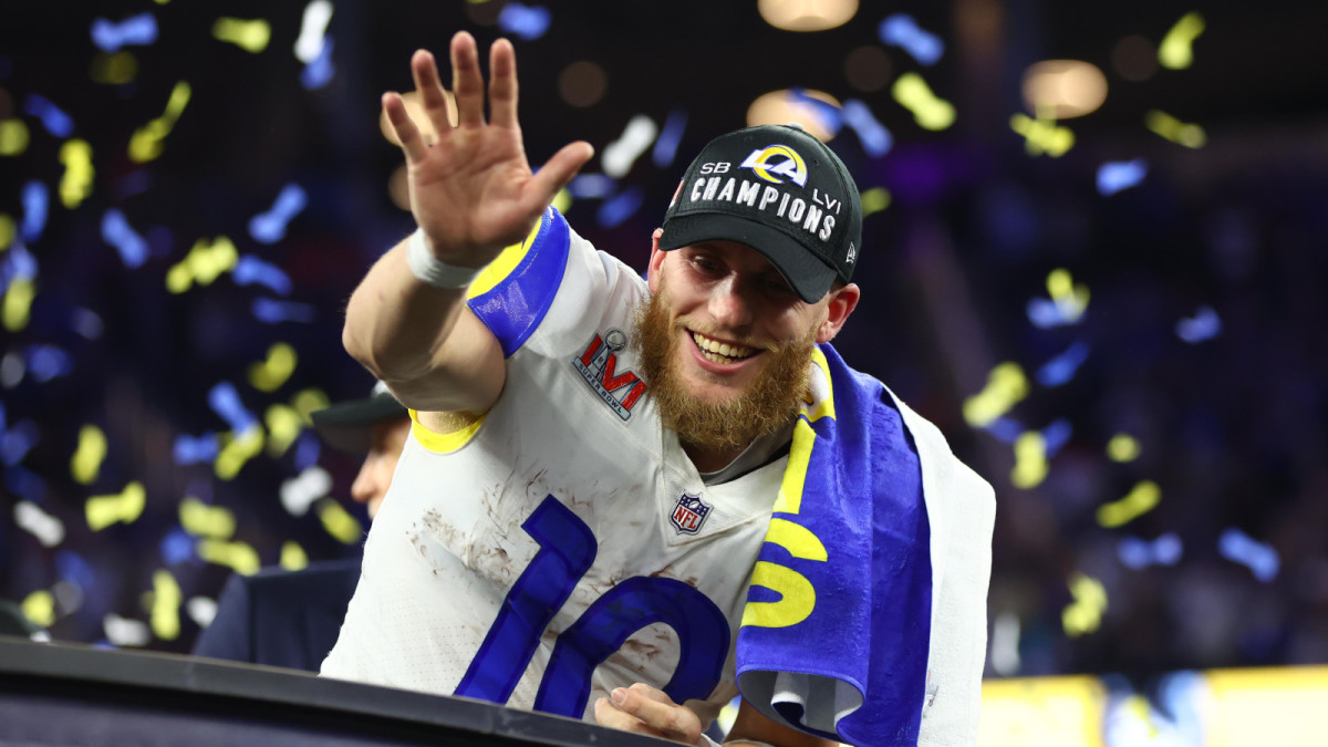 Super Bowl LVI MVP Cooper Kupp waves at the crowd while yellow-and-blue confetti is raining down