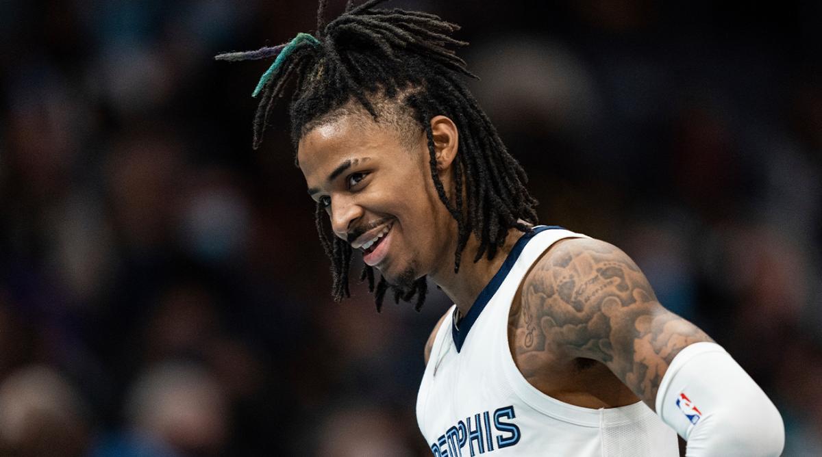 Memphis Grizzlies guard Ja Morant smiles during the second half of the team's NBA basketball game against the Charlotte Hornets in Charlotte, N.C., Saturday, Feb. 12, 2022.
