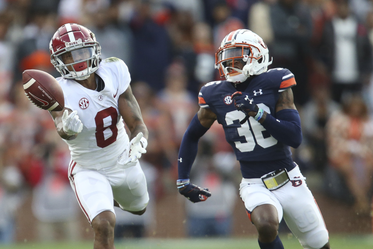Nov 27, 2021; Auburn, Alabama, USA; Alabama Crimson Tide wide receiver John Metchie III (8) cannot catch a pass against Auburn Tigers Tigers defensive back Jaylin Simpson (36) during the first half at Jordan-Hare Stadium. Mandatory Credit: Gary Cosby Jr.-USA TODAY Sports