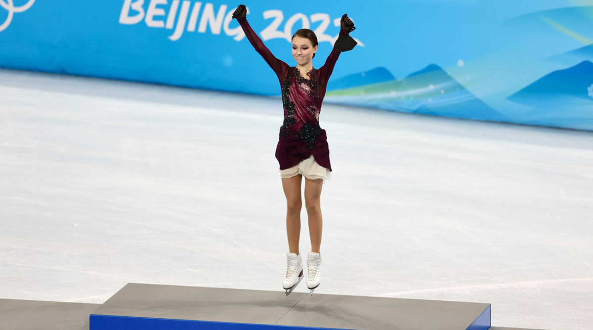 Anna Shcherbakova jumping atop the podium after winning a gold medal in the individual figure skating event.