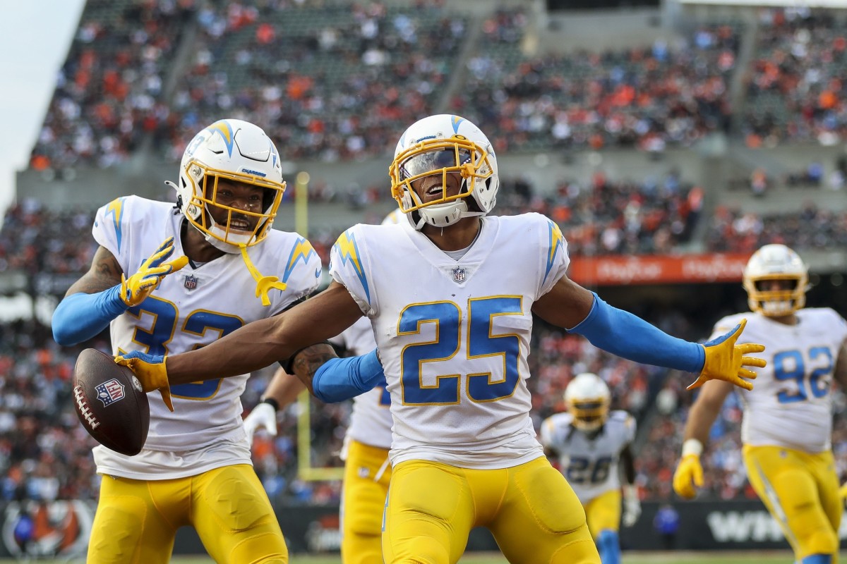 Los Angeles Chargers cornerback Chris Harris Jr. (25) reacts after intercepting the ball with safety Derwin James Jr. (33) in the second half against the Cincinnati Bengals at Paul Brown Stadium.