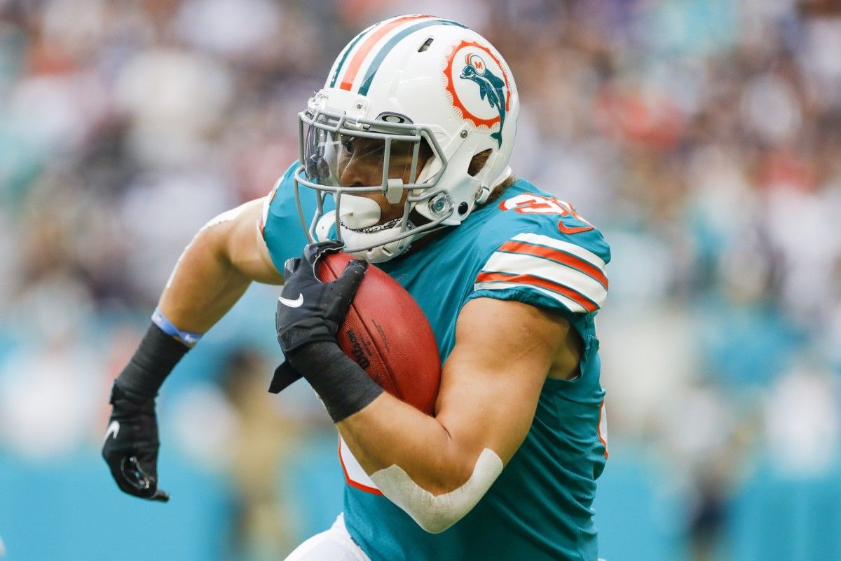 Miami Dolphins running back Phillip Lindsay (31) runs with the football against the New England Patriots during the first quarter at Hard Rock Stadium.