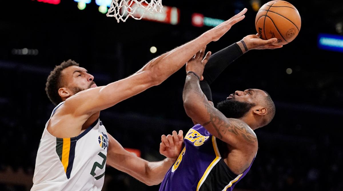Los Angeles Lakers forward LeBron James, right, shoots as Utah Jazz center Rudy Gobert defends during the second half of an NBA basketball game Wednesday, Feb. 16, 2022, in Los Angeles. The Lakers won 106-101.
