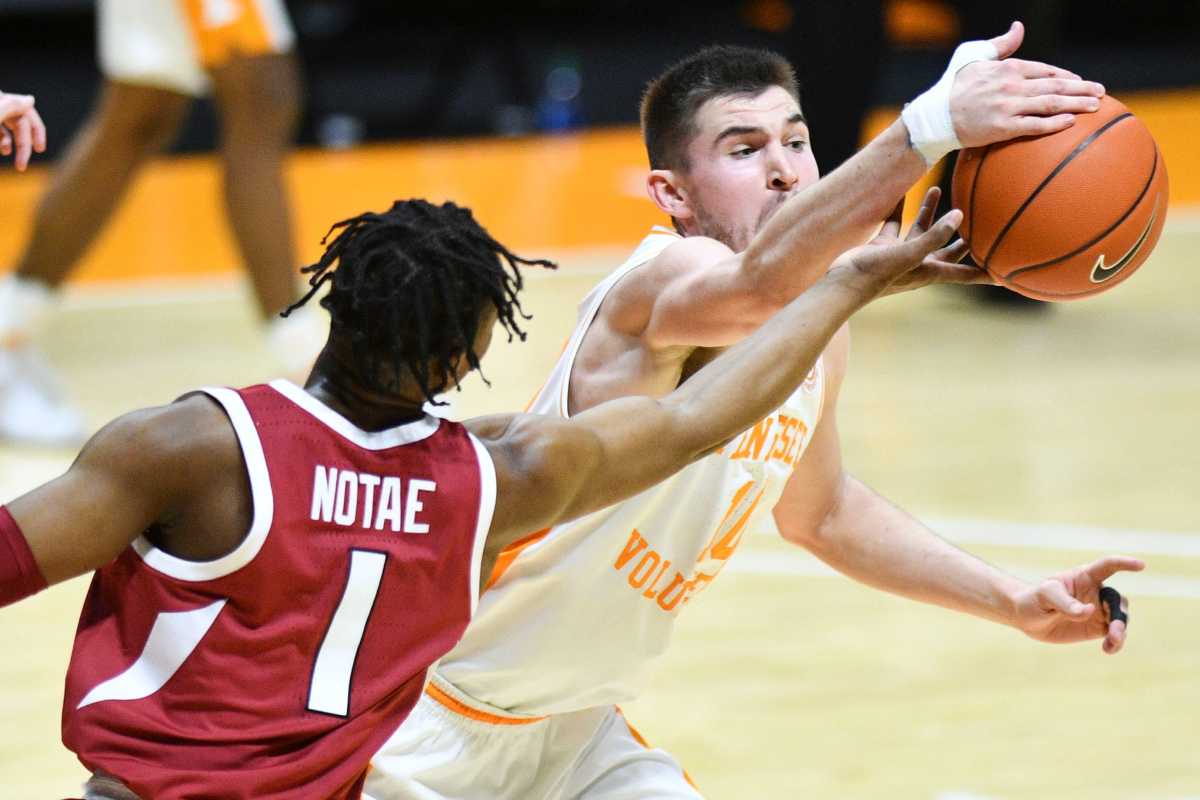 Tennessee forward John Fulkerson (10) grabs the ball as Arkansas guard JD Notae (1) reaches for the ball during a game at Thompson-Boling Arena in Knoxville, Tenn. on Wednesday, Jan. 6, 2021.