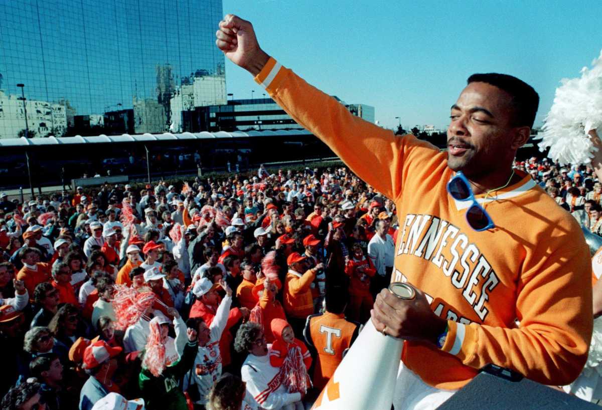 Tennessee fans follow the chant of cheerleader Reggie Coleman during a pep rally at Union Stadium in Dallas Dec. 31, 1989, a warm-up for their Cotton Bowl game against Arkansas.