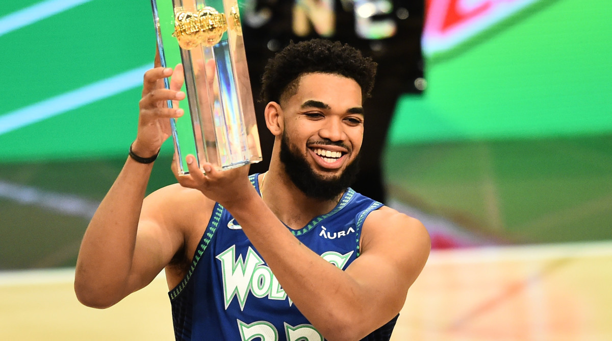 Minnesota Timberwolves center Karl-Anthony Towns (32) celebrates with the trophy after winning the three point contest during the 2022 NBA All-Star Saturday Night at Rocket Mortgage Field House.