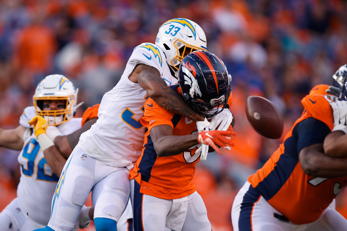 Nov 28, 2021; Denver, Colorado, USA; Denver Broncos quarterback Teddy Bridgewater (5) is sacked by Los Angeles Chargers safety Derwin James Jr. (33) in the first quarter at Empower Field at Mile High. Mandatory Credit: Isaiah J. Downing-USA TODAY Sports