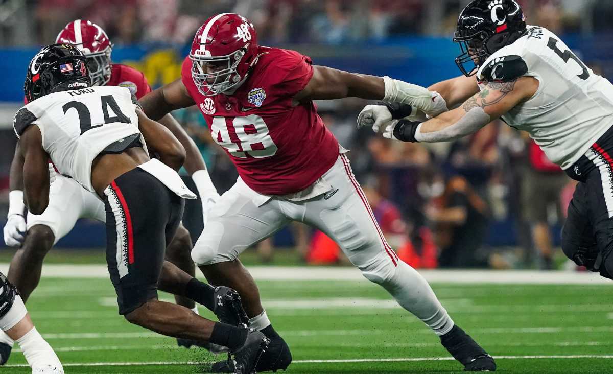 Alabama defensive lineman Phidarian Mathis (48) tackles Cincinnati running back Jerome Ford (24) in the 2021 College Football Playoff Semifinal game at the 86th Cotton Bowl in AT&T Stadium in Arlington, Texas Friday, Dec. 31, 2021.