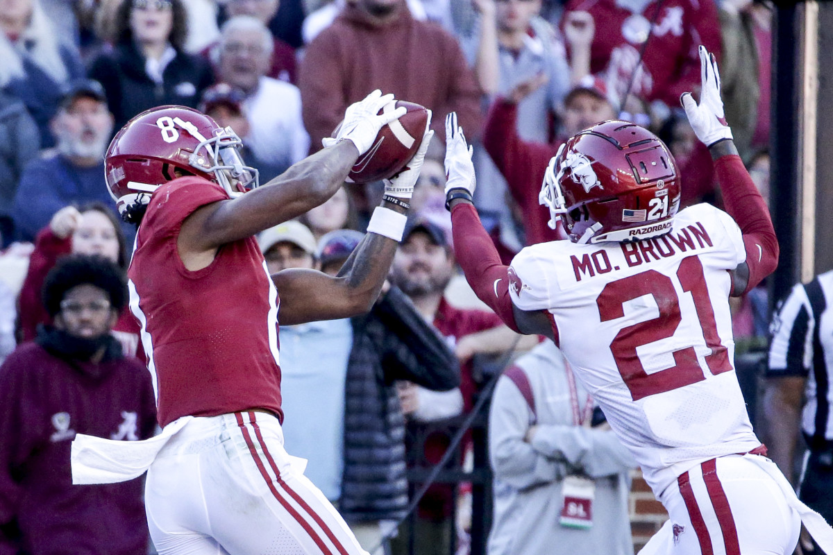 Alabama Crimson Tide wide receiver John Metchie III (8) catches a pass over Arkansas Razorbacks defensive back Montaric Brown (21) for a touchdown during the first half at Bryant-Denny Stadium.
