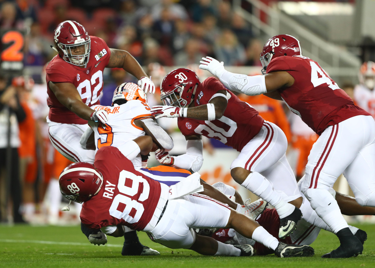 Clemson Tigers running back Travis Etienne (9) is tackled by Alabama Crimson Tide defensive lineman LaBryan Ray (89) , defensive lineman Quinnen Williams (92) and linebacker Mack Wilson (30) in the first half during the 2019 College Football Playoff Championship game at Levi's Stadium.