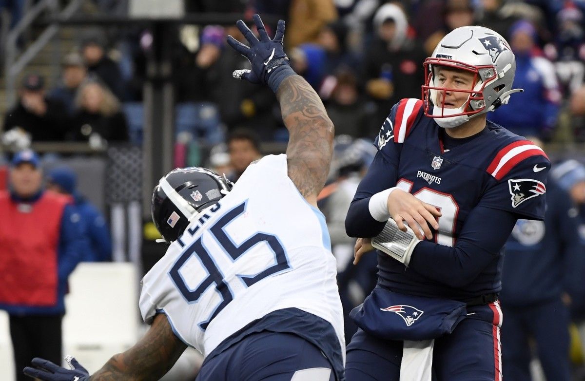 Tennessee Titans defensive tackle Kyle Peko (95) leaps at New England Patriots quarterback Mac Jones (10) to block a pass during the first half at Gillette Stadium.