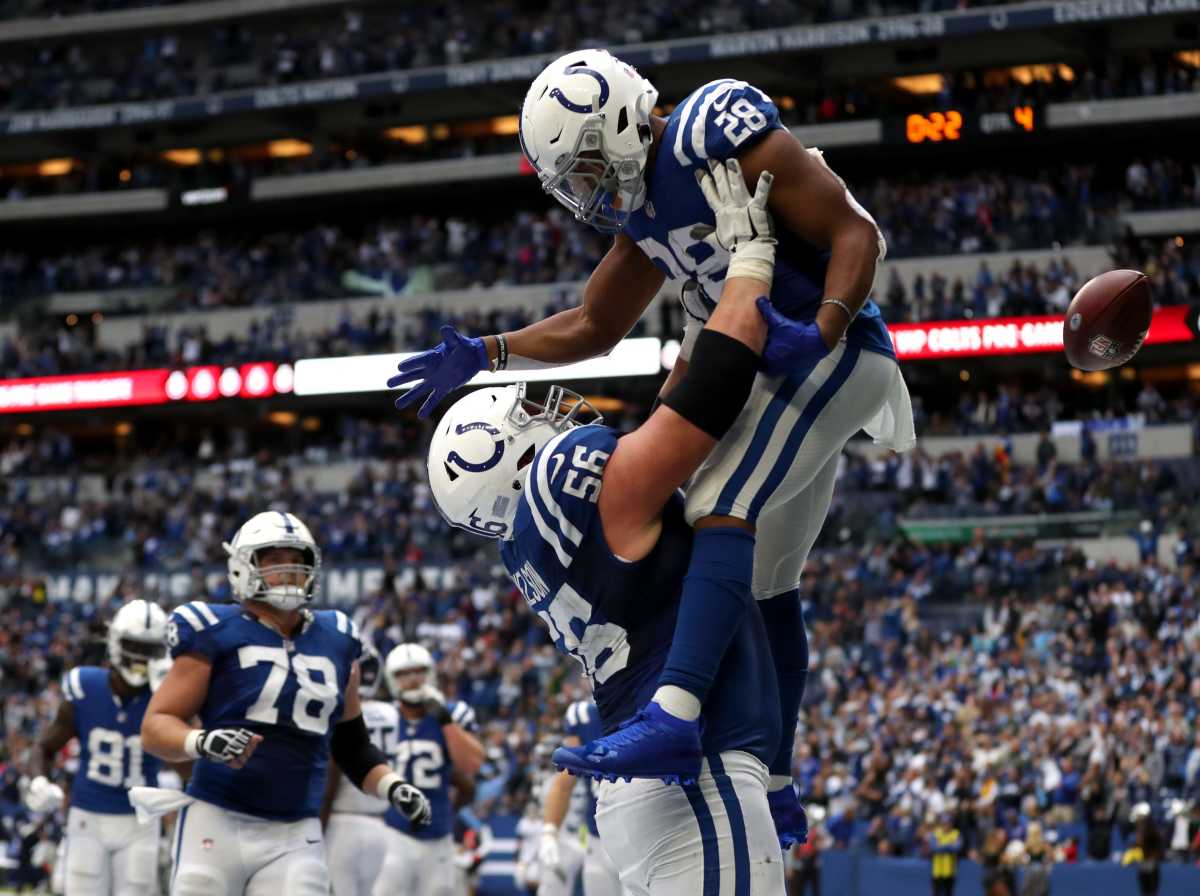 Indianapolis Colts guard Quenton Nelson (56) lifts Indianapolis Colts running back Jonathan Taylor (28) after he scores a touchdown late in the fourth quarter to tie the game Sunday, Oct. 31, 2021, during a game against the Tennessee Titans at Lucas Oil Stadium in Indianapolis.