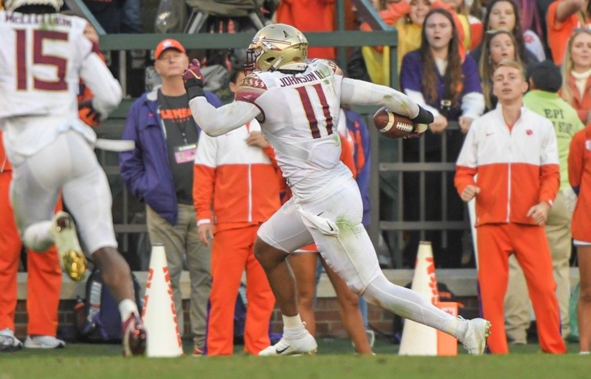 Florida State Seminoles defensive end Jermaine Johnson II (11) scores against the Clemson Tigers during the fourth quarter at Memorial Stadium.