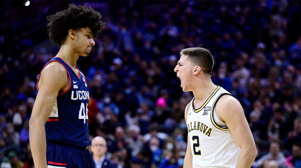 Villanova's Collin Gillespie, right, reacts after scoring a basket as Connecticut's Andre Jackson looks on during the first half of an NCAA college basketball game, Saturday, Feb. 5, 2022, in Philadelphia.