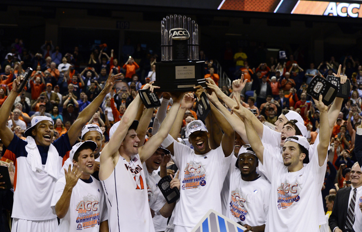 The Virginia Cavaliers men's basketball team raise the trophy for the 2014 ACC Tournament Championship.