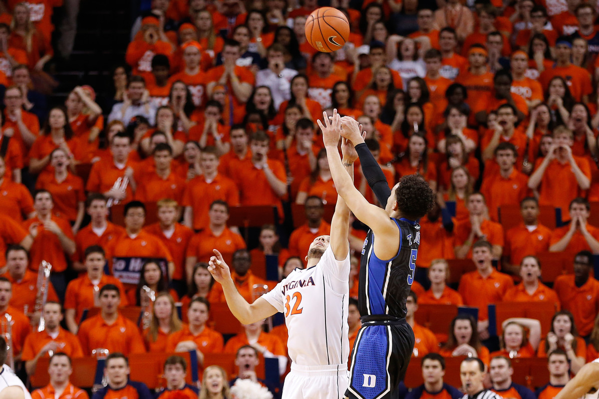 Tyus Jones shoots the game-sealing three-pointer over London Perrantes to clinch a 69-63 victory for the Duke Blue Devils over the Virginia Cavaliers.