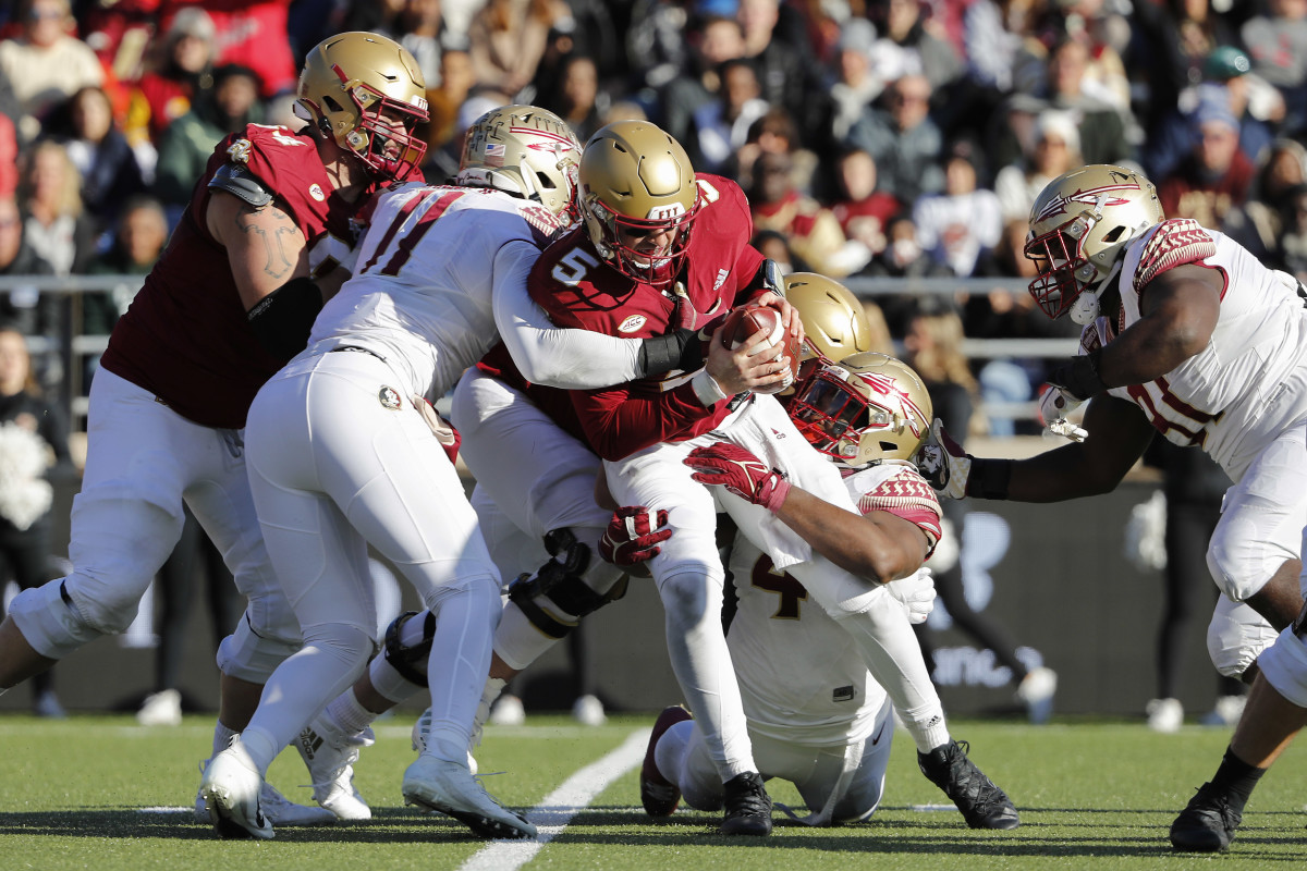 Nov 20, 2021; Chestnut Hill, Massachusetts, USA; Boston College Eagles quarterback Phil Jurkovec (5) is sacked by Florida State Seminoles defensive end Jermaine Johnson II (11) and defensive end Keir Thomas (4) during the first half at Alumni Stadium. Mandatory Credit: Winslow Townson-USA TODAY Sports