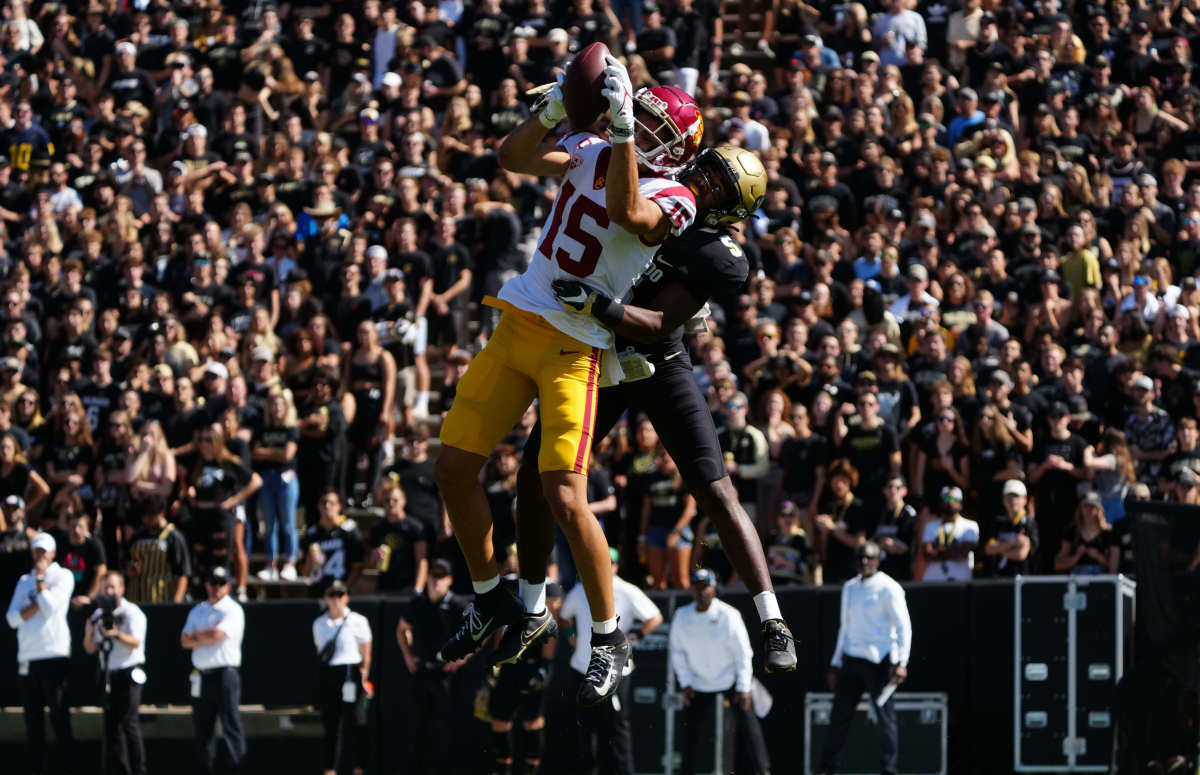 Oct 2, 2021; Boulder, Colorado, USA; USC Trojans wide receiver Drake London (15) pulls in a reception in front of Colorado Buffaloes safety Mark Perry (5) in the first quarter at Folsom Field. Mandatory Credit: Ron Chenoy-USA TODAY Sports