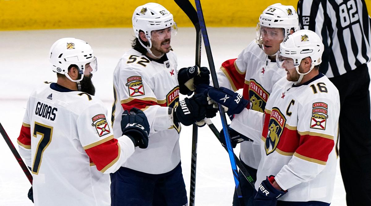 Florida Panthers defenseman MacKenzie Weegar (52) celebrates with teammates after scoring a goal against the Chicago Blackhawks during the third period of an NHL hockey game in Chicago, Sunday, Feb. 20, 2022.