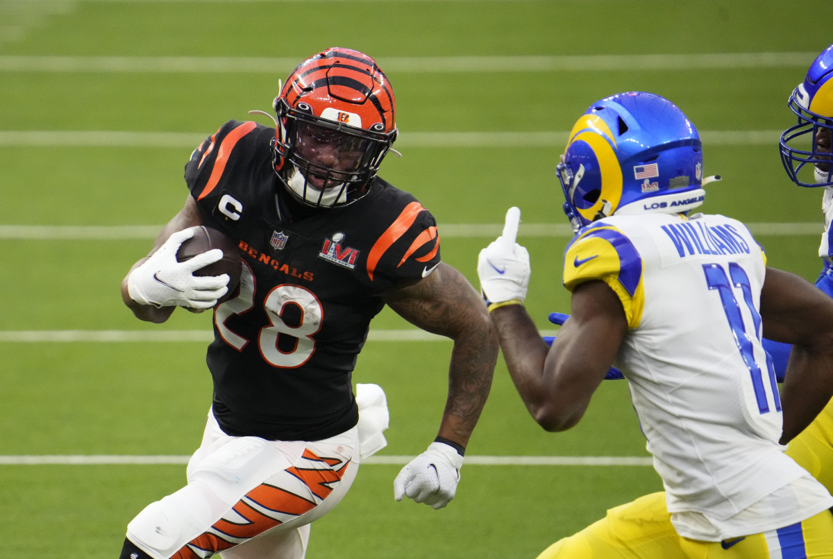 Feb 13, 2022; Inglewood, CA, USA; Cincinnati Bengals running back Joe Mixon (28) runs the ball against Los Angeles Rams cornerback Darious Williams (11) during the second quarter in Super Bowl LVI at SoFi Stadium. Mandatory Credit: Robert Hanashiro-USA TODAY Sports