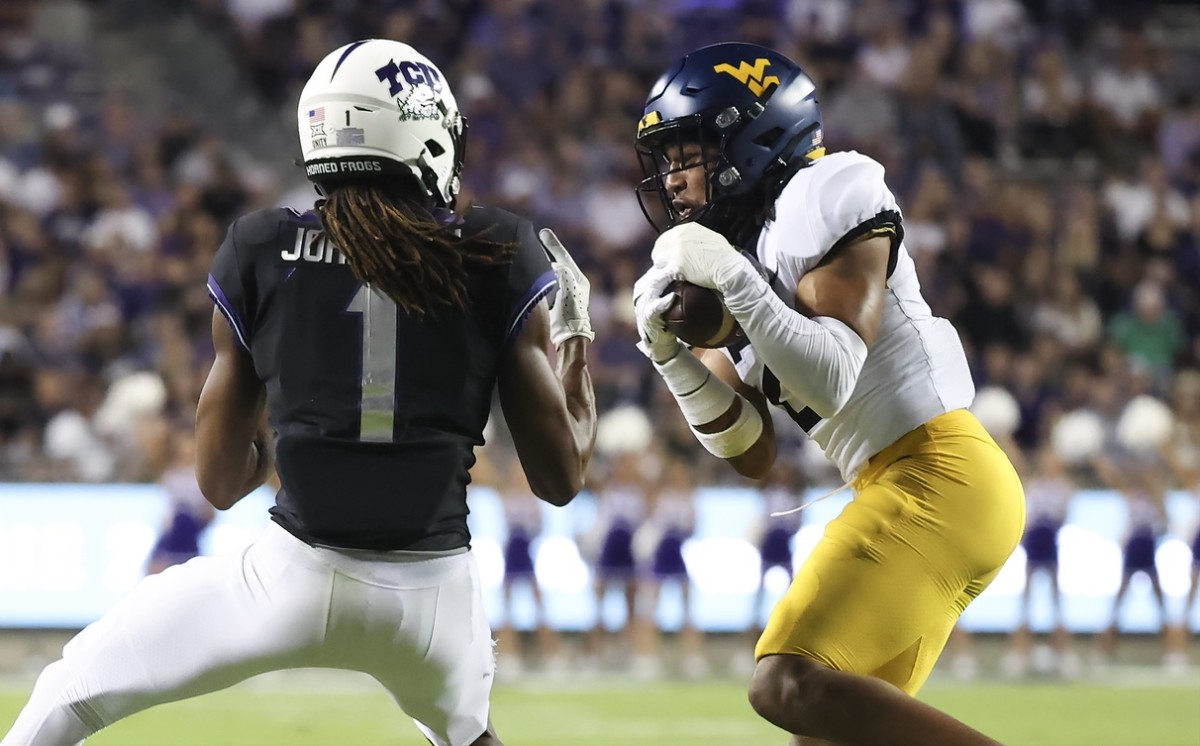 Oct 23, 2021; Fort Worth, Texas, USA; West Virginia Mountaineers cornerback Daryl Porter Jr. (2) intercepts a pass intended for TCU Horned Frogs wide receiver Quentin Johnston (1) during the second half at Amon G. Carter Stadium.