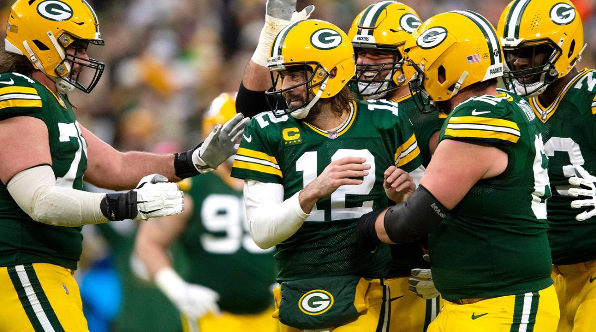 Green Bay Packers quarterback Aaron Rodgers (12) celebrates with teammates after completing a touchdown pass making him the all time leader in touchdown passes in the first quarter during their football game Saturday, December 25, 2021, at Lambeau Field in Green Bay, Wis. Samantha Madar/USA TODAY NETWORK-Wisconsin Green Bay Packers center Lucas Patrick (62) Green Bay Packers offensive tackle Yosh Nijman (73) Gpg Packers Vs Browns 12252021 0002
