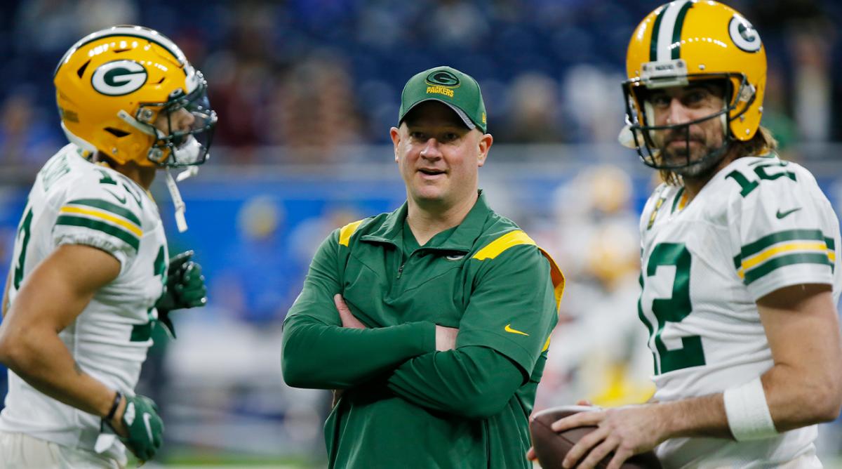 FILE - Green Bay Packers offensive coordinator Nathaniel Hackett seen during pregame of an NFL football game against the Detroit Lions, Sunday, Jan. 9, 2022, in Detroit. At right is Packers quarterback Aaron Rodgers. A person with knowledge of the negotiations told The Associated Press early Thursday morning, Jan. 27, 2022, that the Denver Broncos are finalizing a deal to hire Packers offensive coordinator as their new head coach. The person spoke on condition of anonymity because the deal was still in the works and the team hadn't announced the hiring.