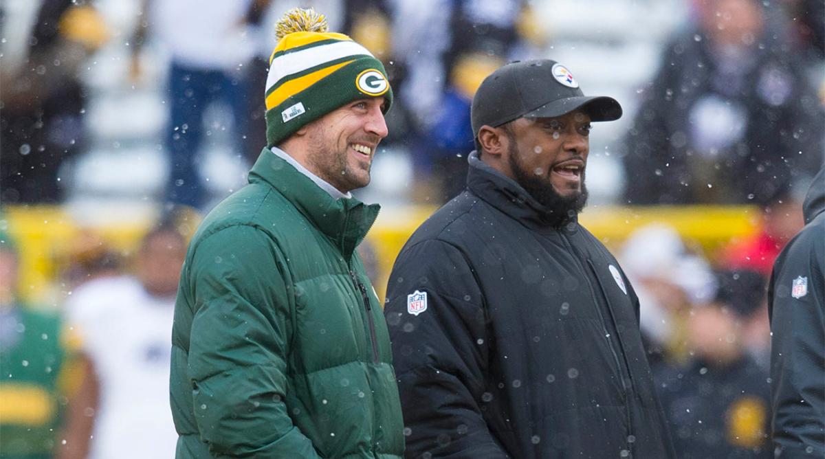 Dec 22, 2013; Green Bay, WI, USA; Green Bay Packers quarterback Aaron Rodgers and Pittsburgh Steelers head coach Mike Tomlin talk during warmups prior to the game at Lambeau Field.