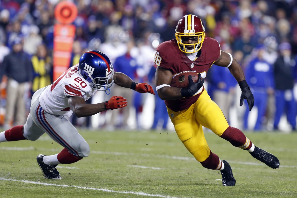 Dec 1, 2013; Landover, MD, USA; Washington Redskins wide receiver Pierre Garcon (88) runs with the ball as New York Giants cornerback Prince Amukamara (20) attempts to tackle in the first quarter at FedEx Field. Mandatory Credit: Geoff Burke-USA TODAY Sports
