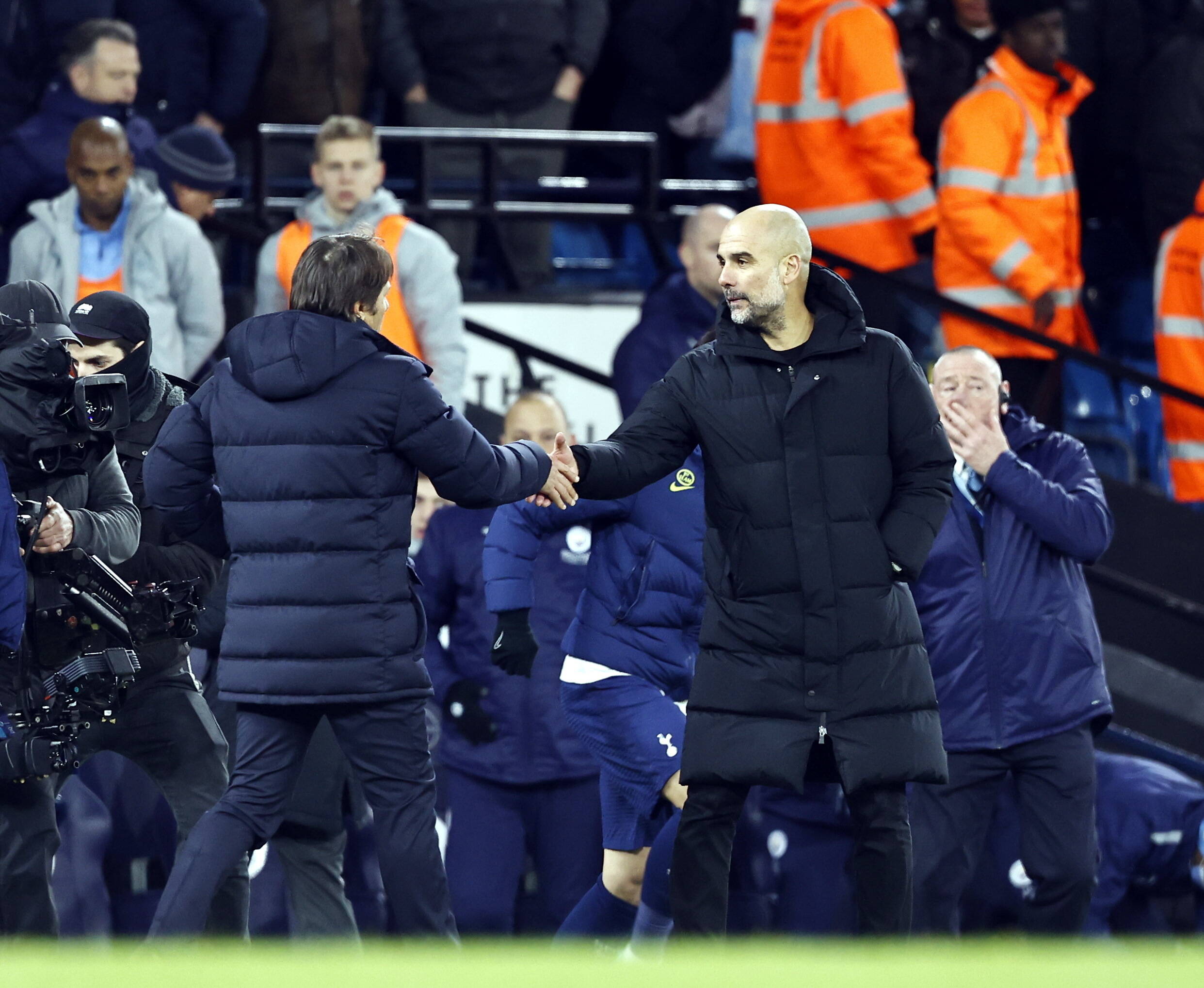 Antonio Conte and Pep Guardiola shake hands after Tottenham's 3-2 win at Man City in February 2022