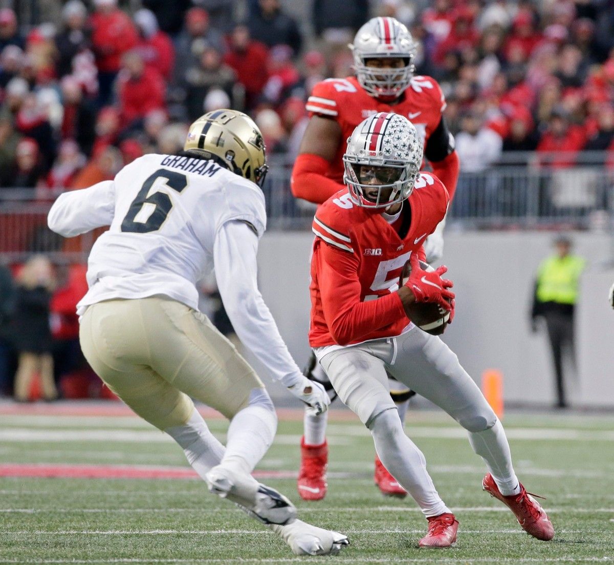 Ohio State Buckeyes wide receiver Garrett Wilson (5) is pursued by Purdue Boilermakers linebacker Jalen Graham (6) during the second quarter of Saturday's NCAA Division I football game at Ohio Stadium in Columbus, Oh., on November 13, 2021. Osu21pur Bjp 362