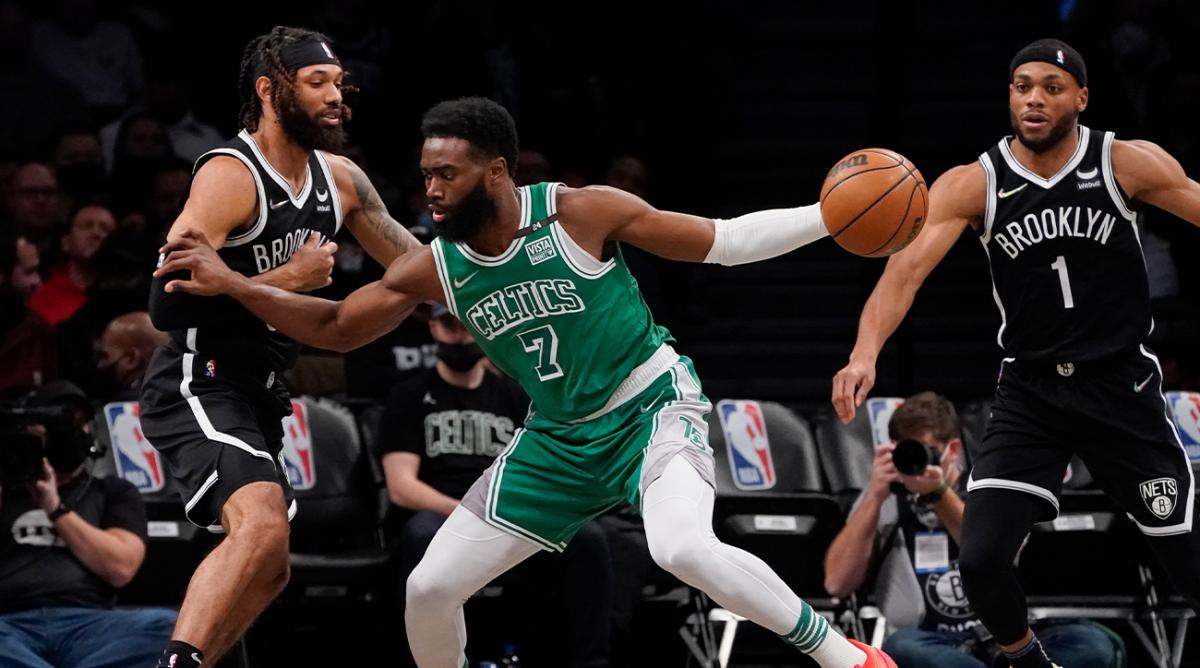Boston Celtics guard Jaylen Brown (7) drives against Brooklyn Nets guard DeAndre' Bembry, left, during the first half of an NBA basketball game, Tuesday, Feb. 8, 2022, in New York.