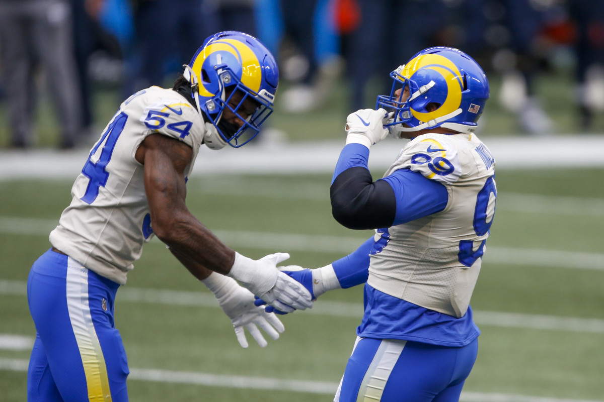 Jan 9, 2021; Seattle, Washington, USA; Los Angeles Rams defensive end Aaron Donald (99) celebrates with outside linebacker Leonard Floyd (54) following a sack against the Seattle Seahawks during the second quarter at Lumen Field. Mandatory Credit: Joe Nicholson-USA TODAY Sports