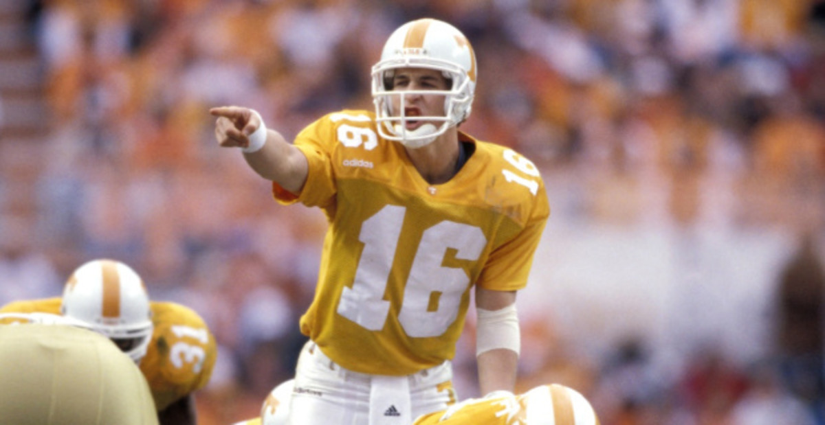 Tennessee Volunteers quarterback Peyton Manning calls a play at the line of scrimmage in a college football game in the SEC.