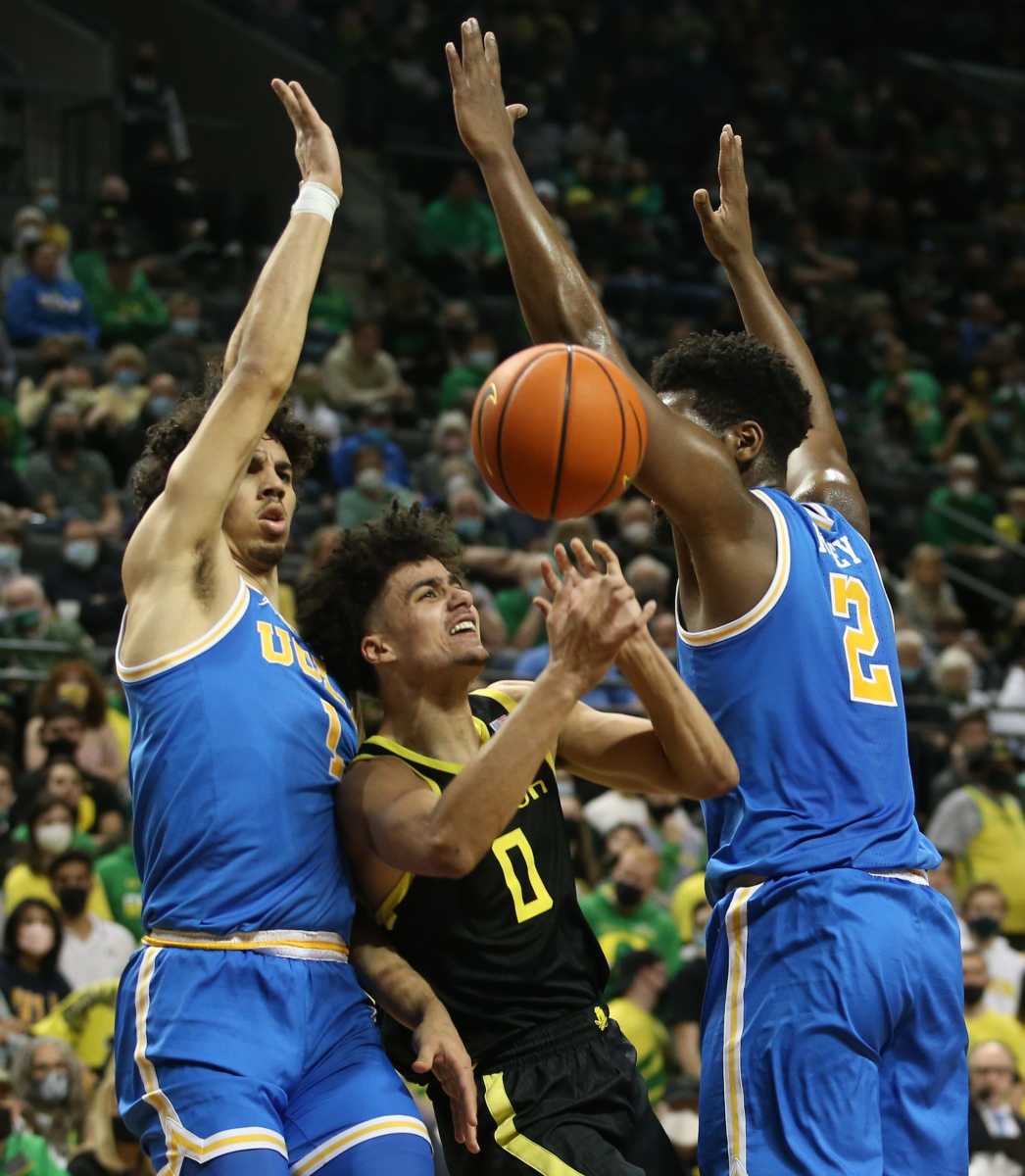 Oregon's Will Richardson, center, is fouled as he goes to the basket between UCLA's Jules Bernard, left, and Cody Riley, right, during the second half Feb. 24, 2022. Eug 022422 Uombb Ucla 07