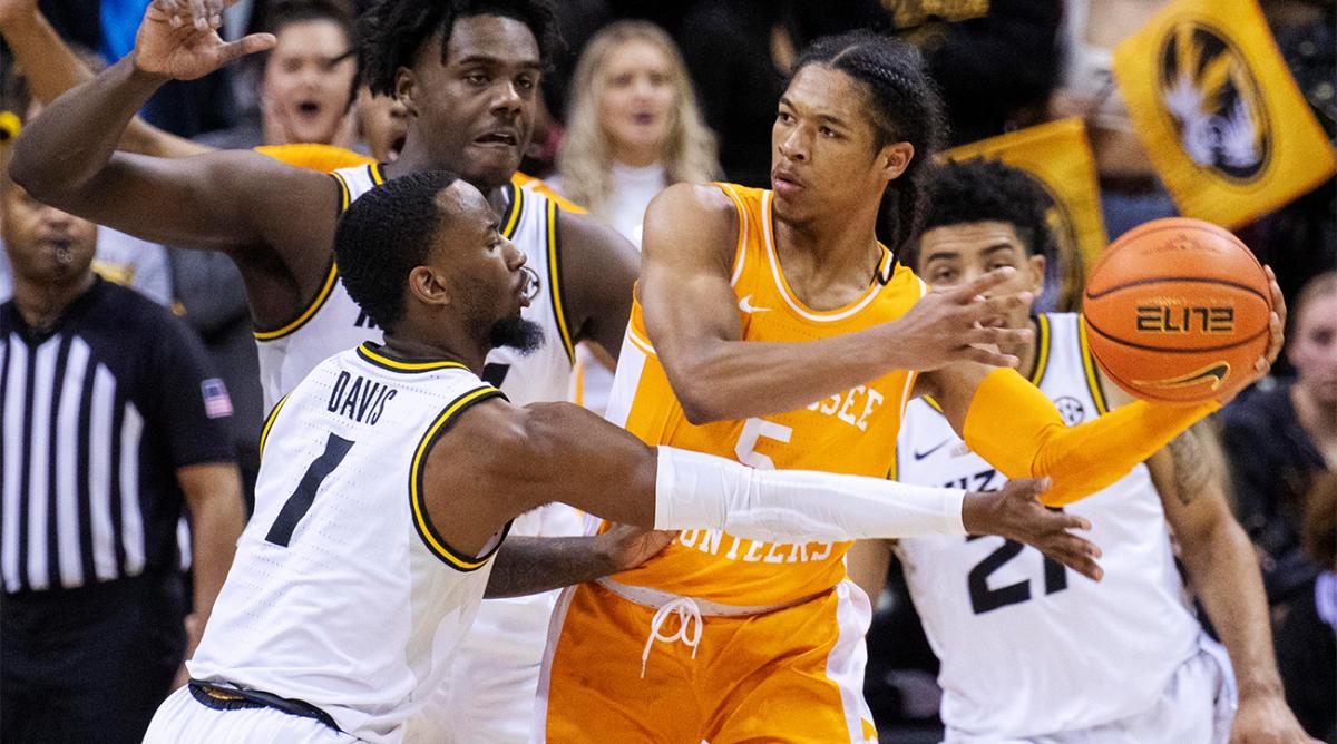 Tennessee's Zakai Zeigler, center, passes the ball away from Missouri's Amari Davis (1), Ronnie DeGray III, right, and Kobe Brown during the second half of an NCAA college basketball game Tuesday, Feb. 22, 2022, in Columbia, Mo.