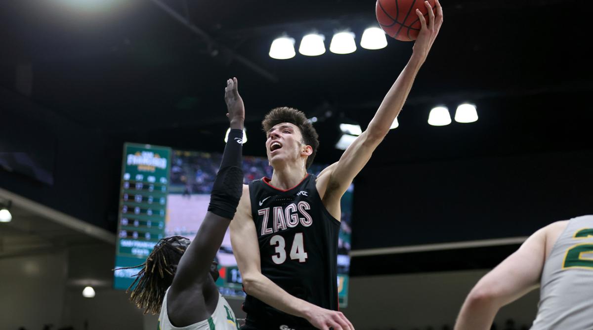 Gonzaga center Chet Holmgren (34) shoots against San Francisco forward Josh Kunen, left, during the second half of an NCAA college basketball game in San Francisco, Calif., Thursday, Feb. 24, 2022.