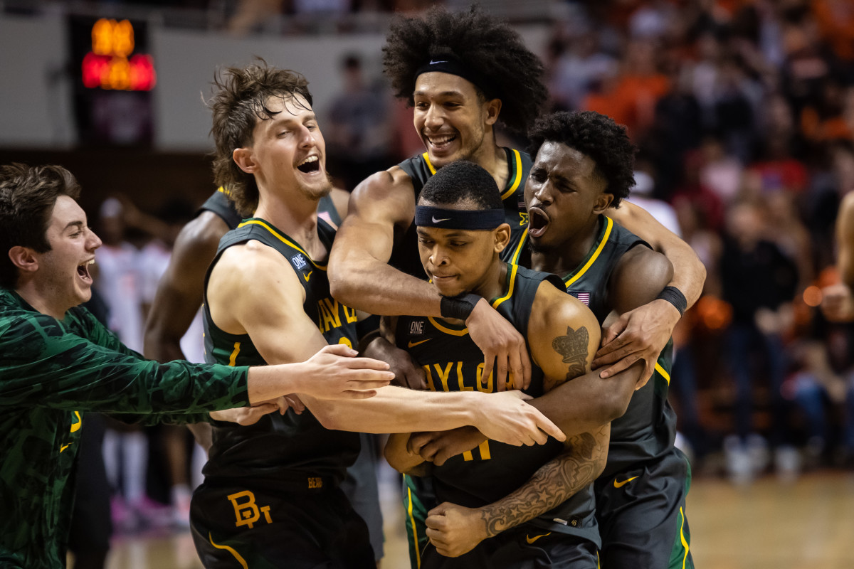Feb 21, 2022; Stillwater, Oklahoma, USA; Baylor Bears teammates celebrate guard James Akinjo (11) pull up jumper to win the game against the Oklahoma State Cowboys at Gallagher-Iba Arena. Mandatory Credit: Rob Ferguson-USA TODAY Sports