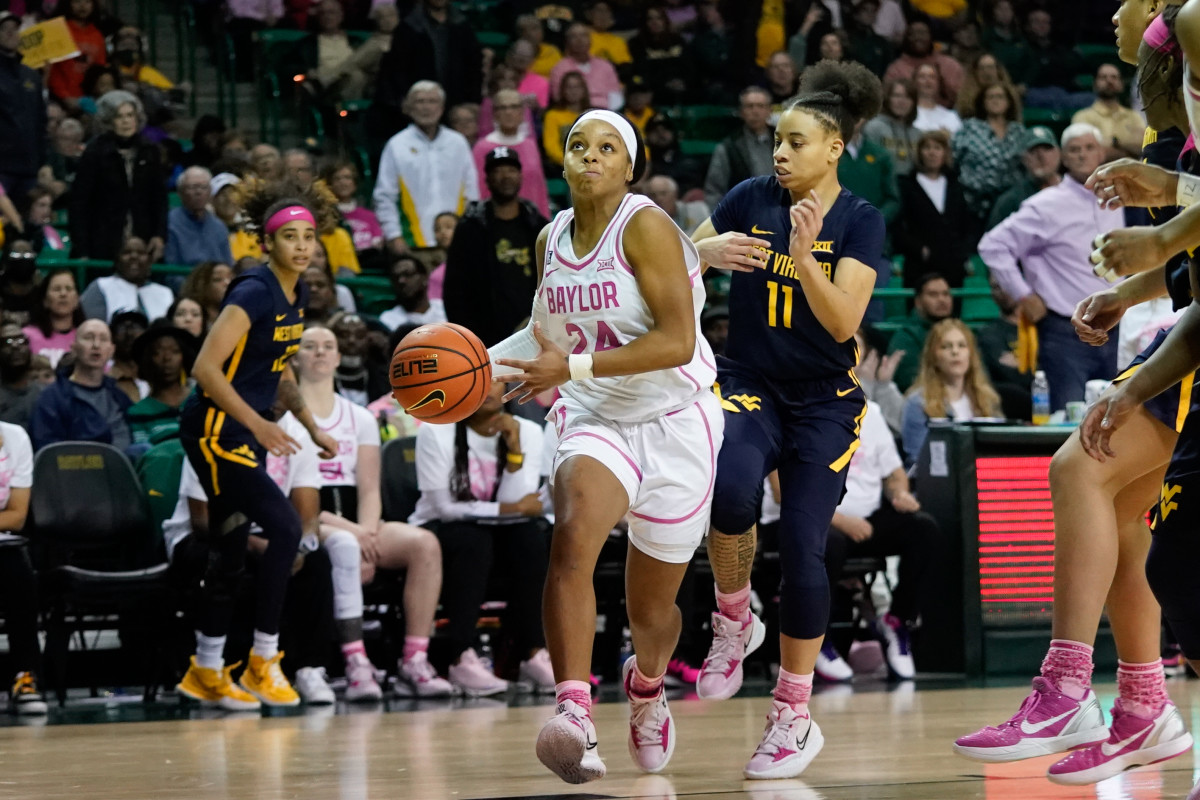 Feb 12, 2022; Waco, Texas, USA; Baylor Lady Bears guard Sarah Andrews (24) looks to score past West Virginia Mountaineers guard Ja'Naiya Quinerly (11) during the second half at Ferrell Center. Mandatory Credit: Chris Jones-USA TODAY Sports