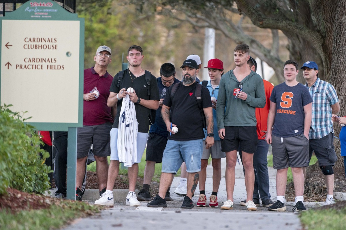 Feb 23, 2022; Jupiter, FL, USA; Baseball fans stand outside a gate in hopes of getting autographs from MLB players who attend contract negotiations at Roger Dean Stadium in Jupiter, Florida on February 23, 2022. Mandatory Credit: Greg Lovett-USA TODAY NETWORK