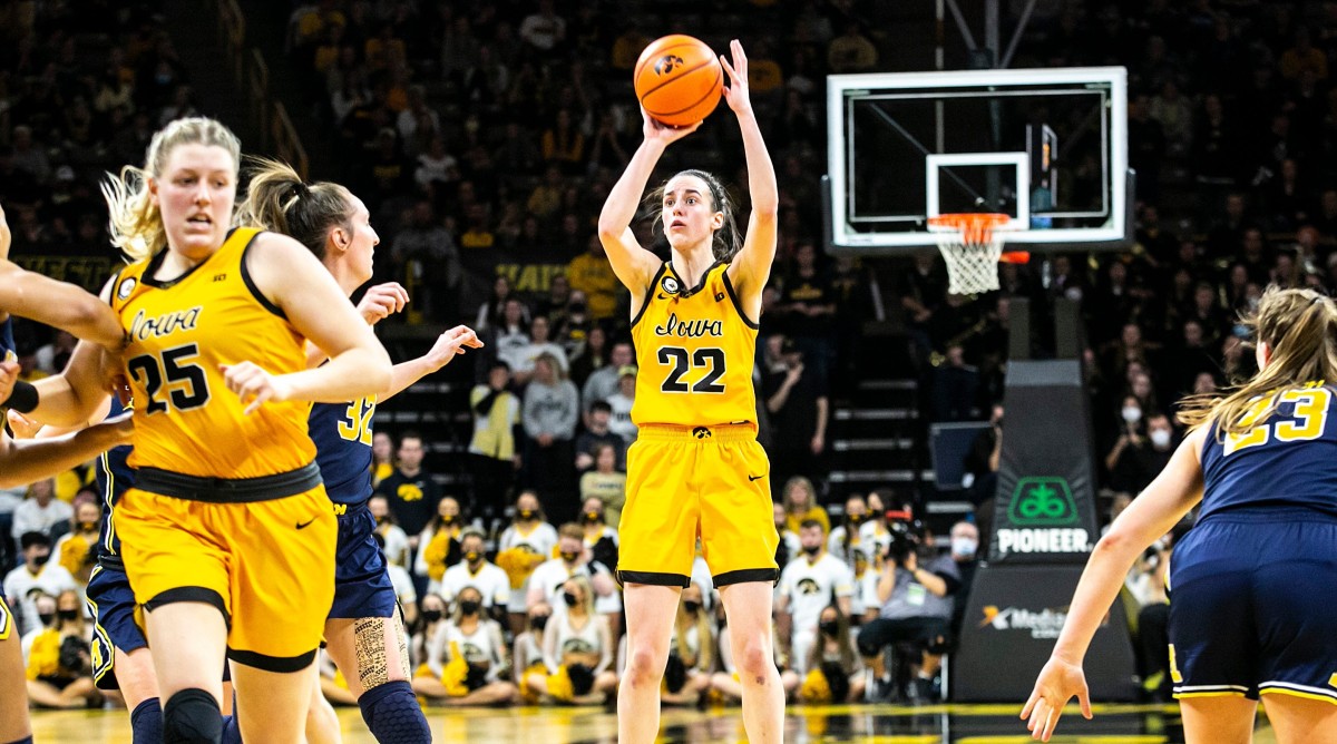 Caitlin Clark makes a 3-point basket during a NCAA Big Ten Conference women’s basketball game against Michigan