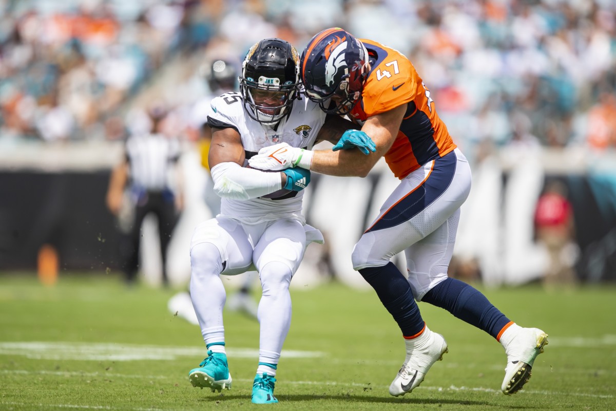Jacksonville Jaguars running back James Robinson (25) is tackled by Denver Broncos linebacker Josey Jewell (47) at TIAA Bank Field.