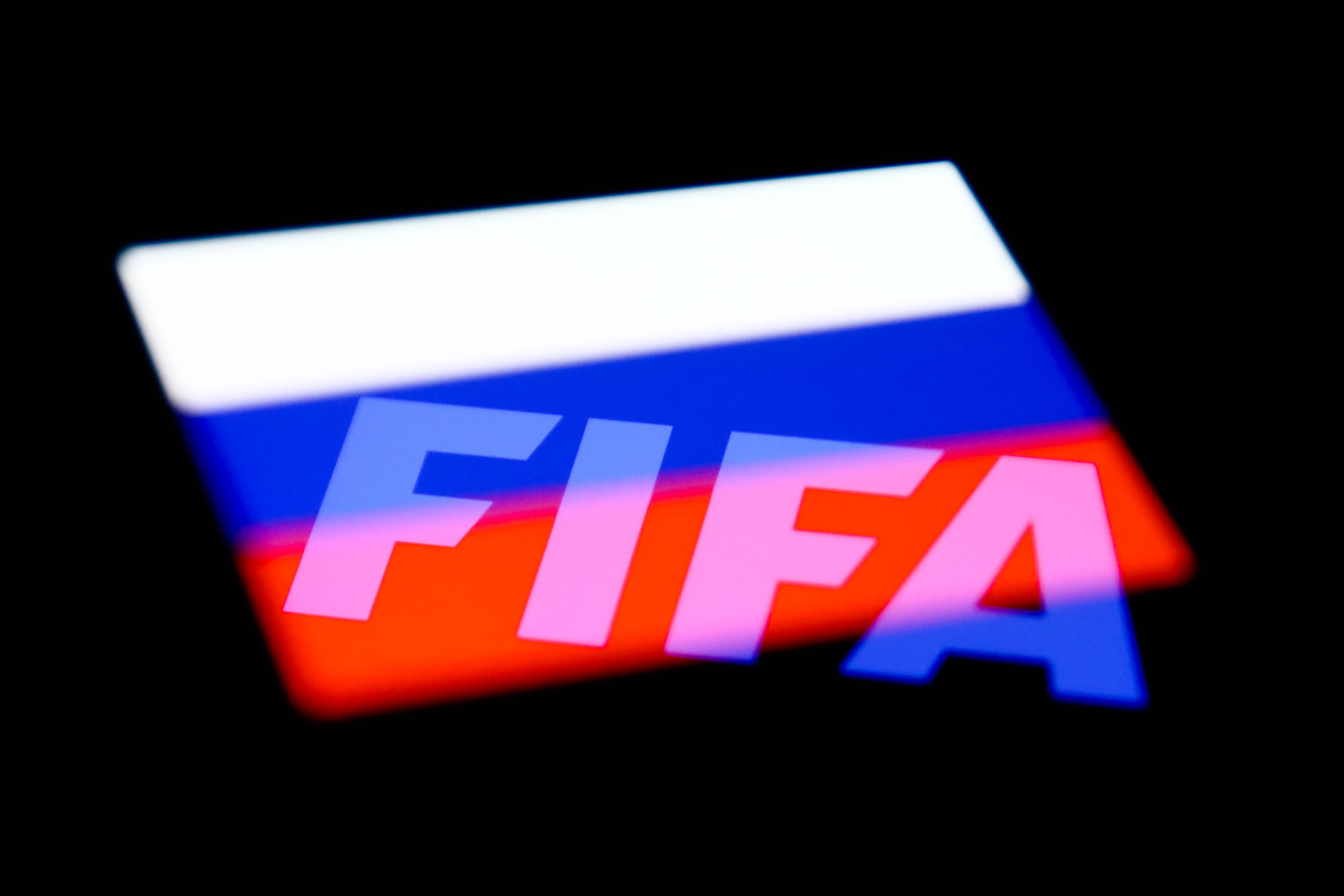 FIFA's logo and the Russian flag are seen displayed on a phone screen