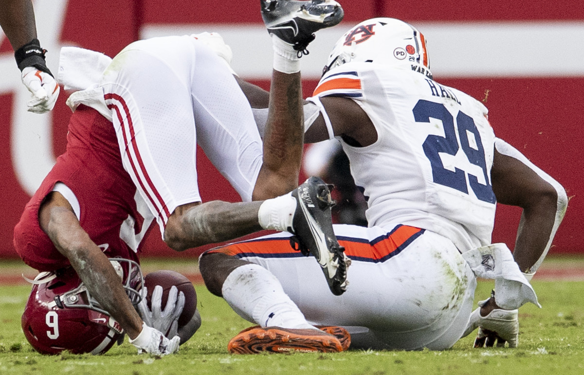Nov 28, 2020; Tuscaloosa, Alabama, USA; Alabama wide receiver DeVonta Smith (6) is put on his head by Auburn defensive lineman Derick Hall (29) at Bryant-Denny Stadium in the Iron Bowl. Mandatory Credit: Mickey Welsh/The Montgomery Advertiser via USA TODAY Sports