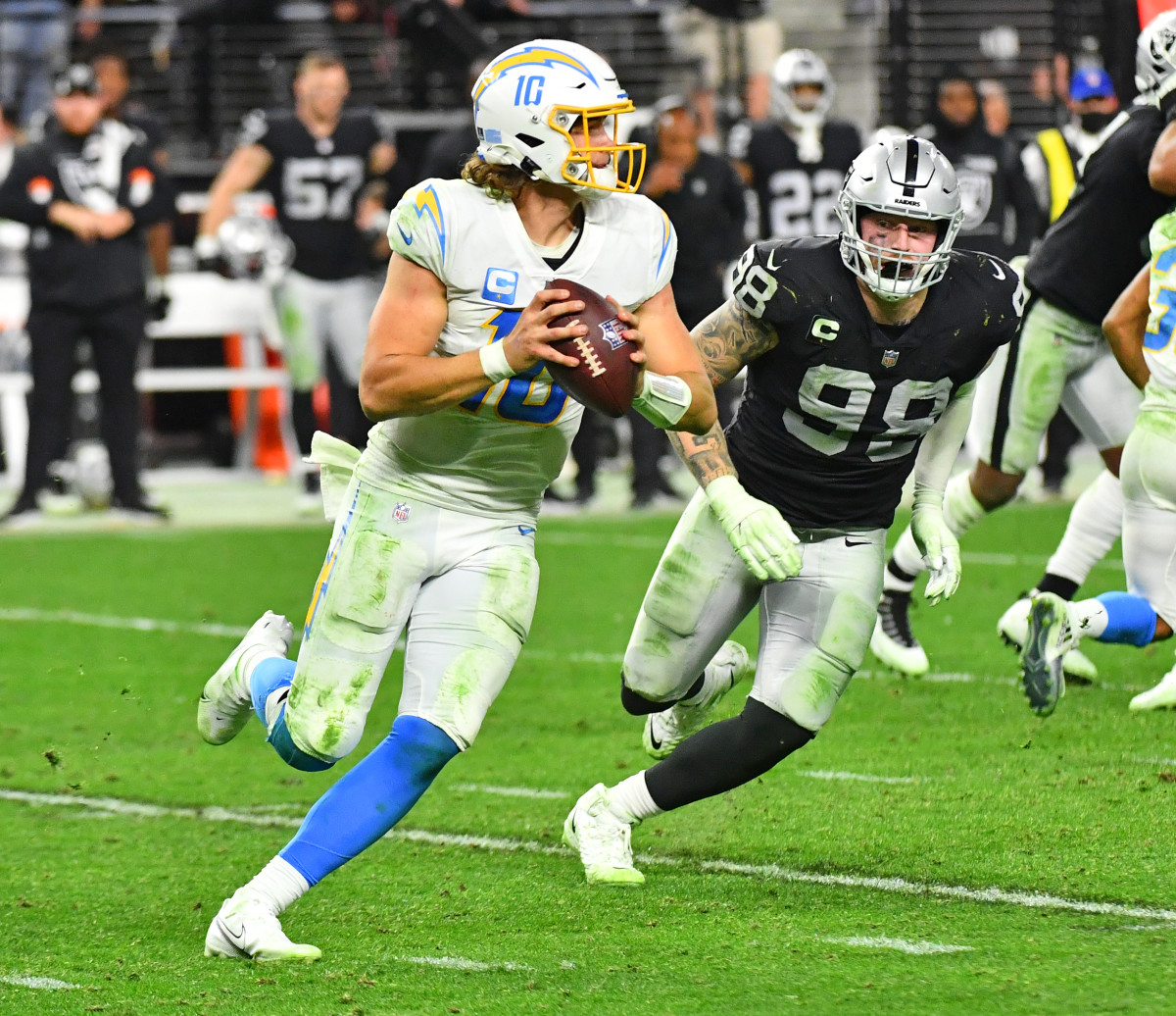 Jan 9, 2022; Paradise, Nevada, USA; Las Vegas Raiders defensive end Maxx Crosby (98) pressures Los Angeles Chargers quarterback Justin Herbert (10) during an overtime period at Allegiant Stadium. Mandatory Credit: Stephen R. Sylvanie-USA TODAY Sports