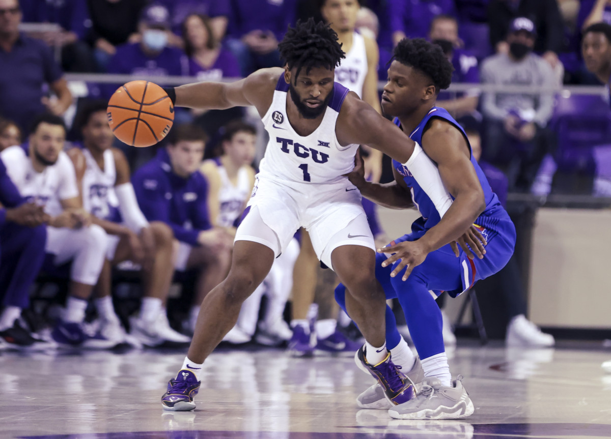 Mar 1, 2022; Fort Worth, Texas, USA; TCU Horned Frogs guard Mike Miles (1) dribbles as Kansas Jayhawks guard Joseph Yesufu (1) defends during the second half at Ed and Rae Schollmaier Arena. Mandatory Credit: Kevin Jairaj-USA TODAY Sports